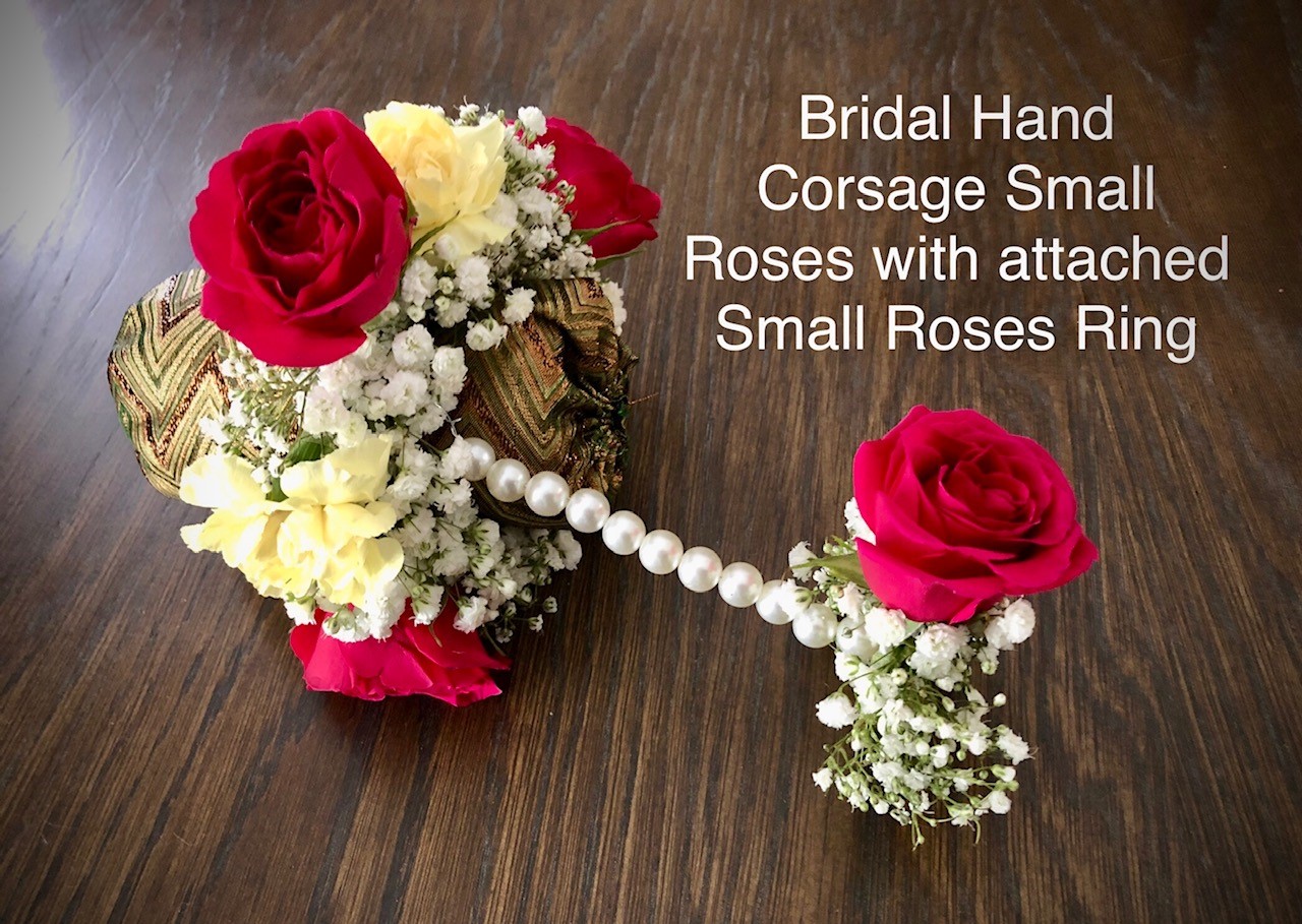 Bridal hand corsage small roses with attached ring  $70   