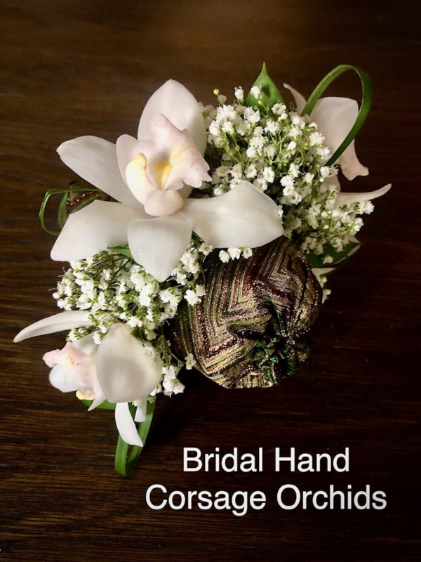 Bridal hand corsage white orchids $40 each            
